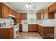 Functional kitchen with wood cabinetry, white appliances, and durable countertops at 6319 Welford Rd, Charlotte, NC 28211