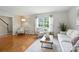 Sun-filled living room featuring hardwood floors, cozy seating, and contemporary accents at 6319 Welford Rd, Charlotte, NC 28211