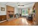 Cozy living room with a brick fireplace, hardwood floors, and a comfortable seating area at 6319 Welford Rd, Charlotte, NC 28211