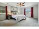 Inviting main bedroom with two windows, soft lighting, and a decorative nautical painting at 6319 Welford Rd, Charlotte, NC 28211