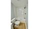 A clean bathroom showcases a streamlined tub and shower combination with integrated shelving and white fixtures at 6490 Alta Ctr, Denver, NC 28037