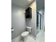 Well-lit bathroom features a modern toilet, black cabinet, and stylish glass-enclosed shower with sleek black fixtures at 6490 Alta Ctr, Denver, NC 28037