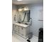 Bright bathroom with double vanity, black fixtures, large mirror and sleek design at 6490 Alta Ctr, Denver, NC 28037
