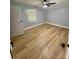 Bright, empty bedroom with modern flooring, neutral walls, and a contemporary ceiling fan at 6490 Alta Ctr, Denver, NC 28037