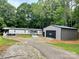 Charming home with a large garage, surrounded by lush greenery and a well-maintained driveway at 6490 Alta Ctr, Denver, NC 28037