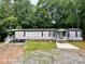 Charming home with front yard, stone accents, black shutters, and a covered porch entry at 6490 Alta Ctr, Denver, NC 28037
