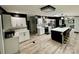 Modern kitchen with stainless steel appliances, white cabinetry, quartz countertops, and a center island at 6490 Alta Ctr, Denver, NC 28037