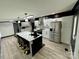 Contemporary kitchen featuring stainless steel appliances, quartz countertops, and a large island with seating at 6490 Alta Ctr, Denver, NC 28037