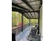 Relaxing covered porch with outdoor seating, perfect for enjoying the peaceful, wooded surroundings at 6490 Alta Ctr, Denver, NC 28037