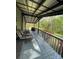 Inviting covered porch with lounge chairs and outdoor furniture, ideal for unwinding and enjoying nature views at 6490 Alta Ctr, Denver, NC 28037