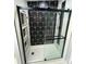 Modern bathroom shower with sliding glass door, built-in shelving, and stylish black-and-white tile at 6490 Alta Ctr, Denver, NC 28037