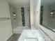 Well lit bathroom features bath/shower combo with decorative blue marble at 709 Falls Church Rd, Charlotte, NC 28270