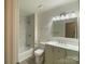 Beautiful bathroom featuring shower and bath combo with marble tile and dual sink vanity at 709 Falls Church Rd, Charlotte, NC 28270