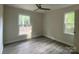 An inviting bedroom featuring sleek gray floors and a ceiling fan at 709 Falls Church Rd, Charlotte, NC 28270