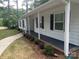 Charming home showcasing fresh landscaping, a manicured lawn, and a welcoming covered porch at 709 Falls Church Rd, Charlotte, NC 28270