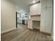Kitchen with white cabinets, quartz countertops, stainless appliances, and desk area at 709 Falls Church Rd, Charlotte, NC 28270