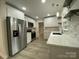 Renovated kitchen featuring white cabinets, quartz countertops, and stainless appliances at 709 Falls Church Rd, Charlotte, NC 28270