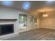 Living room with fireplace, doors to sunroom, light gray walls, and neutral floors at 709 Falls Church Rd, Charlotte, NC 28270