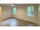 Bright main bedroom with natural light, ceiling fan, and attractive floors at 709 Falls Church Rd, Charlotte, NC 28270