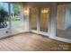 Patio featuring wood floors and view of landscaped backyard at 709 Falls Church Rd, Charlotte, NC 28270