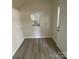 Interior of the shed with gray vinyl flooring and a window at 709 Falls Church Rd, Charlotte, NC 28270