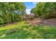 Lush backyard offers a serene escape with mature trees and landscaping around the home at 727 W Main Street Ext, Lincolnton, NC 28092