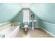 Bright bathroom featuring mint green walls, bathtub, and pedestal sink at 727 W Main Street Ext, Lincolnton, NC 28092