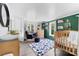 Inviting Bedroom with soft lighting, a wooden crib, and a comfortable rocking chair at 727 W Main Street Ext, Lincolnton, NC 28092