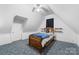Attic bedroom featuring a bed, ceiling fan, carpeted floors, and white walls at 727 W Main Street Ext, Lincolnton, NC 28092