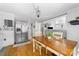 Open dining area featuring hardwood floors, a spacious table, and seamless flow to the kitchen at 727 W Main Street Ext, Lincolnton, NC 28092