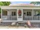 Inviting screened-in front porch with decorative wreath and charming details at 727 W Main Street Ext, Lincolnton, NC 28092