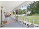 Relaxing screened-in front porch with seating area, perfect for enjoying the outdoors at 727 W Main Street Ext, Lincolnton, NC 28092