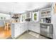 Bright kitchen with white cabinets, stainless steel appliances, and an adjacent dining area at 727 W Main Street Ext, Lincolnton, NC 28092