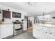 Well-lit kitchen featuring stainless steel appliances, white cabinets, and an eat-in area at 727 W Main Street Ext, Lincolnton, NC 28092