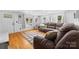 Inviting living room with a cozy sectional sofa, hardwood floors, and large windows at 727 W Main Street Ext, Lincolnton, NC 28092