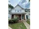 Charming two-story townhouse with brick accents and a covered front porch entrance at 7857 Petrea Ln, Charlotte, NC 28227