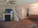 Cozy living room featuring a fireplace and staircase to the upper level at 7857 Petrea Ln, Charlotte, NC 28227