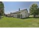 Sprawling backyard with lush lawn and patio views at 8524 Loxton Cir, Charlotte, NC 28214