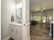 Stylish powder room adjacent to the living room featuring a vanity and a round mirror at 8524 Loxton Cir, Charlotte, NC 28214