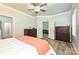 Light-filled bedroom with wood floors, two dressers and access to en suite bathroom and living room at 8524 Loxton Cir, Charlotte, NC 28214