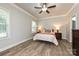 Bright bedroom with a queen-size bed, natural light, and wood floors at 8524 Loxton Cir, Charlotte, NC 28214