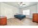 Bedroom features light gray walls, wood floors, a ceiling fan, and a closet at 8524 Loxton Cir, Charlotte, NC 28214