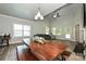 Bright dining area with large windows, hardwood floors and a wooden dining table and bench set at 8524 Loxton Cir, Charlotte, NC 28214