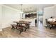 Inviting dining area showcasing a wooden table and benches with an adjacent kitchen and office space at 8524 Loxton Cir, Charlotte, NC 28214
