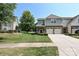 Charming townhome featuring a brick facade, two-car garage, and a well-maintained lawn with mature trees at 8524 Loxton Cir, Charlotte, NC 28214
