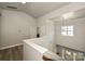 Bright hallway features wood floors, natural light, and an open view to the home's entry way and a secondary floor at 8524 Loxton Cir, Charlotte, NC 28214