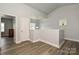 Bright hallway features wood floors, natural light, and entry to the second bedroom at 8524 Loxton Cir, Charlotte, NC 28214