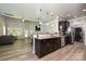 Open kitchen with dark wood cabinets, stainless steel appliances, and a view to the living room at 8524 Loxton Cir, Charlotte, NC 28214