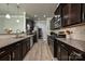 Modern kitchen with dark wood cabinets, granite countertops, stainless steel appliances, and wood floors at 8524 Loxton Cir, Charlotte, NC 28214