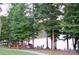 Picturesque lake view from the park with mature trees and a seating area, perfect for enjoying nature at 8524 Loxton Cir, Charlotte, NC 28214